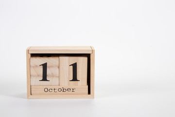 Wooden calendar October 11 on a white background