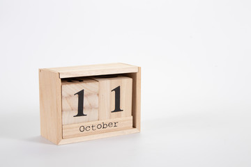 Wooden calendar October 11 on a white background