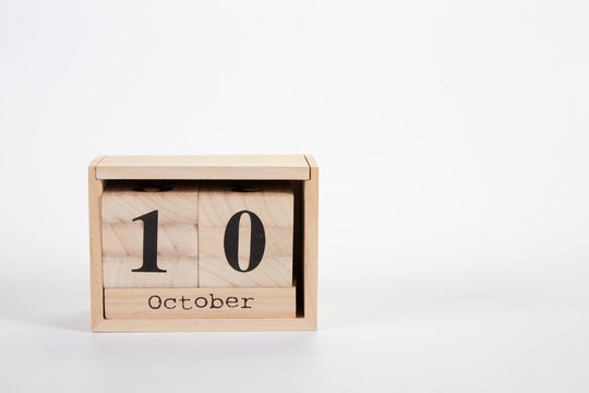 Wooden calendar October 10 on a white background