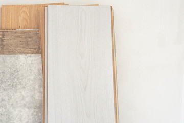 Timber, laminate flooring propped on white wall