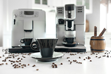Two coffee machines in the home kitchen with a wooden container with coffee beans.