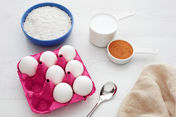 Various dairy products for baking on white wooden kitchen table