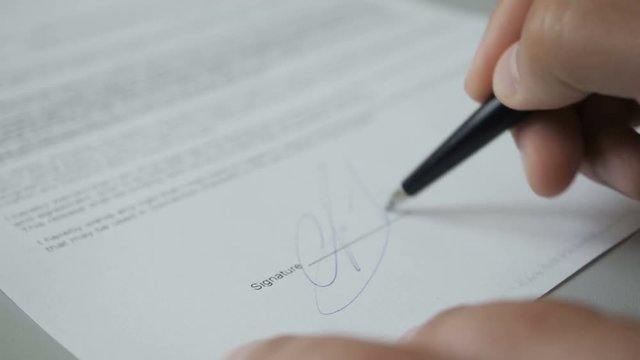 Notary public in office stamping document. Businessman stamping document table, director approving contract, paperwork. Man is approve documents by signing and stamping papers. Closeup. UHD 4K.