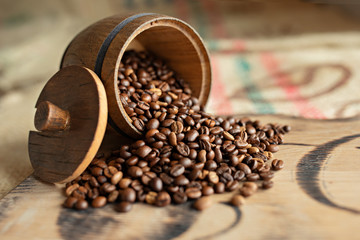 Scattered coffee beans on a wooden board. Close-up