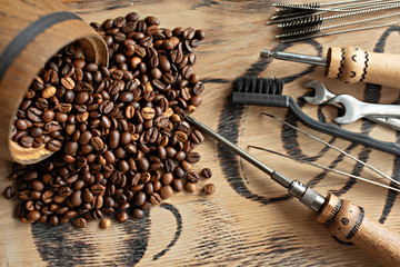 Tools for repairing coffee machines close-up. Coffee beans, wooden board, coffee machine, kitchen table