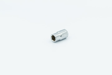 This capture of a silver socket wrench on a white background and in a studio light 