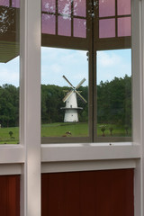 Old Dutch wind mill seen through a window © erwin