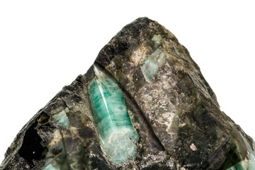 Macro emerald stone mineral in rock on white background