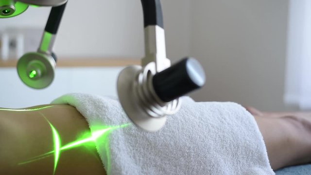 Laser treatment, loose weight on stomach. Medical center or spa.