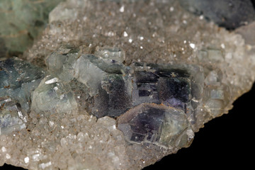 macro mineral fluorite stone on black background