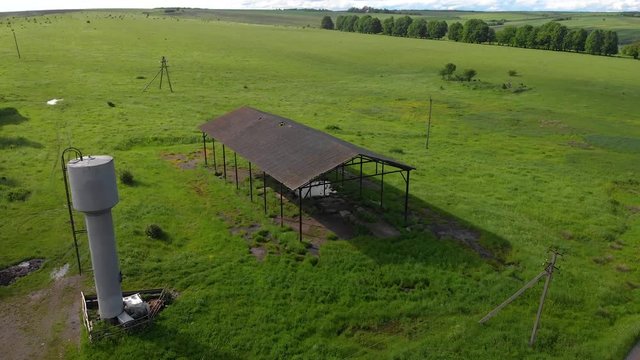 thrown metal hangar, with an old water tower aerial background nature wallpapper