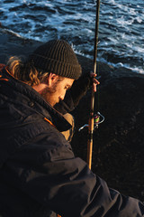 Handsome brutal bearded fisherman wearing coat