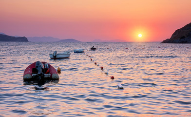Sundown and boats on the sea