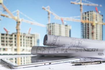 house under construction on blueprints - building project