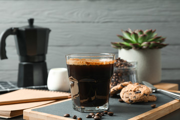 Coffee time accessories on black table against grey background, space for text. Break time