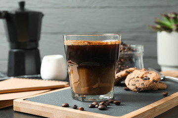 Coffee time accessories on black table against grey background, space for text. Break time