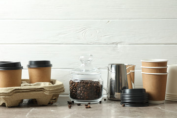 Coffee time accessories on grey table against white wooden background, space for text. Break time