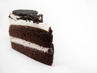 Chocolate cake slice with curl on white background