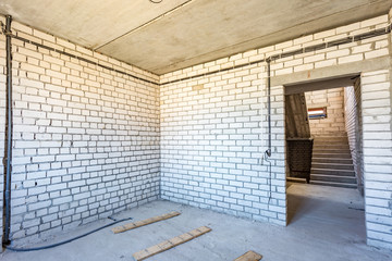 empty interior in house without repair with white silicate brick walls