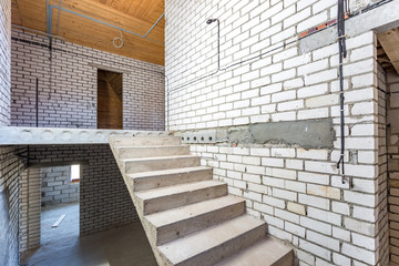 Obraz premium empty interior in house without repair with white silicate brick walls