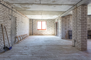 empty interior in house without repair with white silicate brick walls