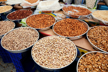 Various assorted nuts on in the pan on the counter at the market