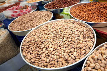 Various dried fruits in the pan on the counter of an authentic market