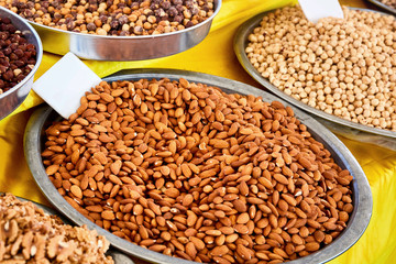 Roasted almond in a pan on the counter of an outdoor market