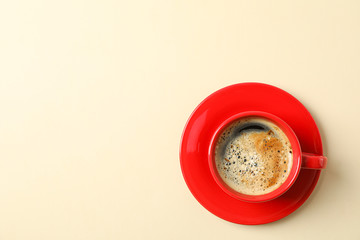 Cup of coffee with frothy foam on color background, space for text and top view. Coffee time accessories