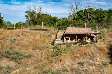 log storage shed at the top of the hill surrounded by trees