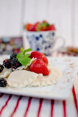 Dumplings with cheese and strawberries. Sweet dinner