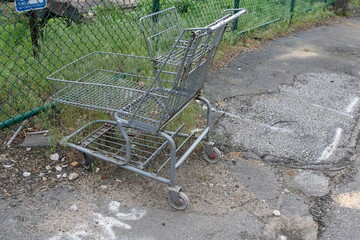 Old rusty abandoned metal shopping cart left outside 
