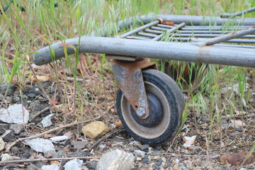 Fototapeta premium Old rusty abandoned metal shopping cart left outside 