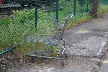 Old rusty abandoned metal shopping cart left outside 