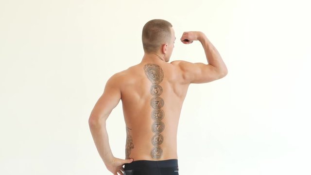 Young Man Showing Work of Muscles of Body - Spine