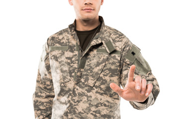 cropped view of soldier in uniform pointing with finger isolated on white