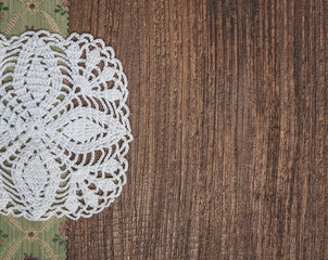 Floral fabric and lace on old wood background