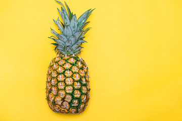 Fresh organic pineapple isolated on yellow background.