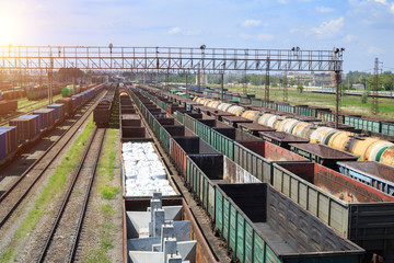 Fototapeta na wymiar Freight trains on city cargo terminal. Railways in train parking. Arain arrived at the station. Cargo train platform with freight train container at depot in port use for export logistics background.