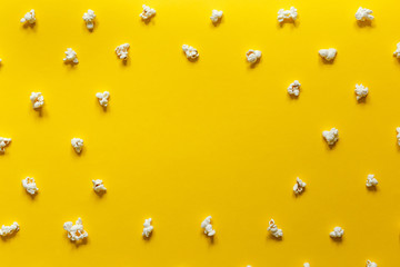 Popcorn pattern on yellow background with space for text. Top view.