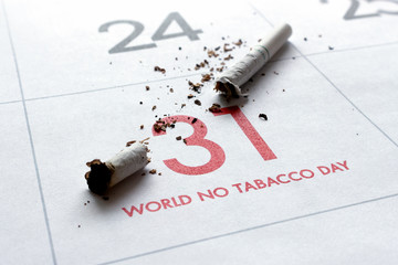 world no tobacco day concept. cigarettes on calendar with soft-focus and over light in the...