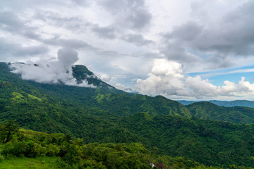 Blue sky high peak mountains fog hills mist scenery national park views at Phu Tub Berk, Khao Koh, Phetchabun Province, Thailand
