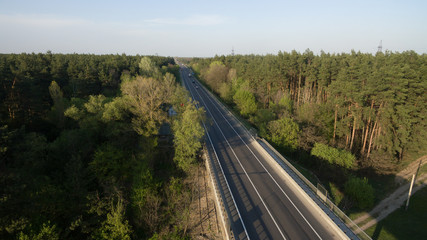 Obraz na płótnie Canvas View from the height of the green forest and the road