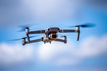 Drone with high resolution digital camera on the sky. Weather is cloudy