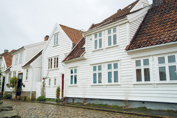 Fototapeta na wymiar Beautiful street with traditional white wooden houses in Stavanger, Norway. Summer