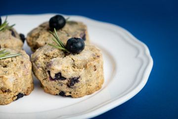 Fresh Baked Raspberry and Blueberry oatmeal wheat Scones set on Blue Background.