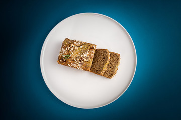 Almond bread loaf with Almond diced and Banana sliced set on Blue Background.
