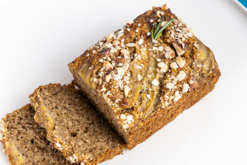 Almond bread loaf with Almond diced and Banana sliced set on Blue Background.