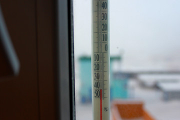 the thermometer outside the window shows minus 40