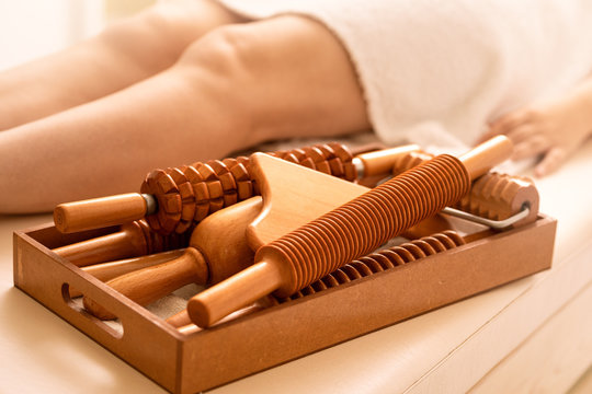 On the massage table is a tool for ant cellulite massage of Madero therapy.